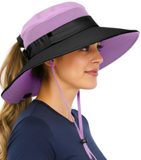 Woman wearing the GearTOP Navigator Ponytail Series purple safari sun hat with UPF 50+ UV protection, wide brim, ponytail-friendly design, breathable mesh panels, and adjustable chin strap for outdoor adventures.