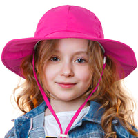 Child wearing the pink GearTOP Voyager kids sun hat featuring UPF 50+ sun protection and a wide brim for outdoor activities.