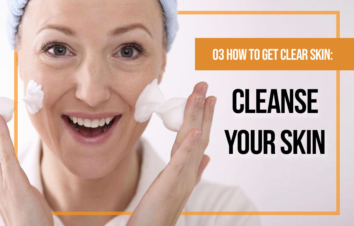 Lady cleansing her face to get clear skin