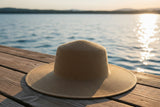Wide brim UPF 50+ sun hat worn outdoors for full face and neck UV protection