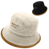 Flip Reversible Bucket Hat featuring black and crème reversible corduroy and cotton twill design with hidden pocket, removable strap, and packable unisex style for everyday wear and travel.
