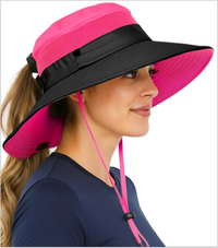 Woman wearing the GearTOP Navigator Ponytail Series hot pink wide brim sun hat with UPF 50+ protection, breathable mesh panels, ponytail opening, and adjustable chin strap for hiking, fishing, gardening, and beach adventures.