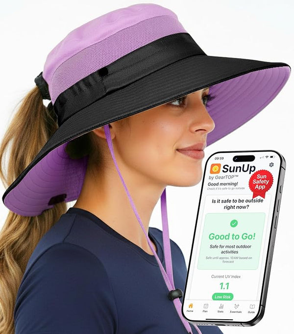 Woman in purple and black GearTOP ponytail sun hat using SunUp UV safety app, illustrating skin protection during outdoor activities.