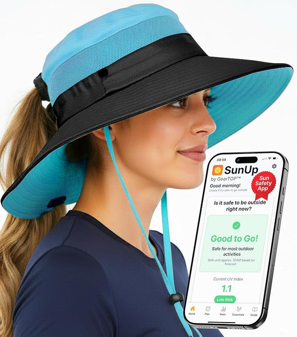 Woman with blue and black GearTOP UPF 50+ hat and SunUp app, showcasing sun protection for hiking, travel, and adventure.