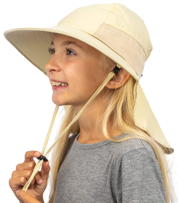 Girl wearing beige kids sun hat with wide brim and neck flap for UPF 50+ sun protection outdoors